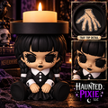 Wednesday candle holder with black braids, black dress, and a decorated tray featuring a stitched hand